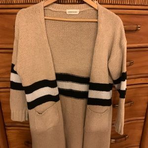Tan knit sweater with black and white stripes